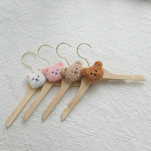 Cute wooden clothes hangers with plush bear heads, 4 colors set for kids garment organizing.