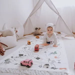 Nordic style children play mat lifestyle detail view, featuring farm animal print and cute tassels.
