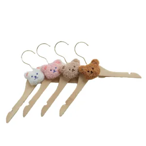 Cute wooden clothes hangers with plush bear heads for kids clothes storage and nursery organization.