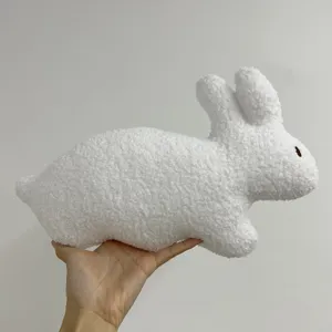 Detailed view of a cute white plush rabbit toy with soft curly fleece, perfect for kids.