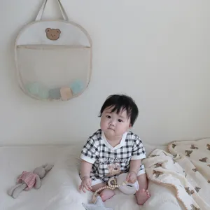 Detail shot of the cute baby bath storage net bag with bear decor in a cozy room setting.