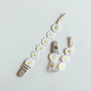Cute white daisy embroidery baby pacifier clip detail, safe teething anti-loss strap.