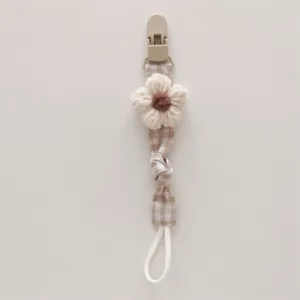 Handmade knitted flower pacifier clip for babies, anti-drop fabric teething strap detail.