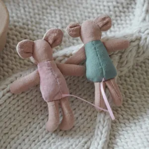 Miniature cute cloth mouse doll detail shot, soft knitted background texture view.