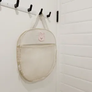 Mesh hanging storage bag detail showing breathable white mesh and cute pink rabbit embroidery.