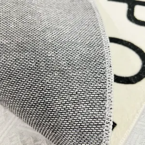 Detailed closeup of children room rug backing, showing non-slip texture and fine edge stitching.