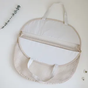Detailed view of the beige mesh hanging storage bag, showing breathable material and handles.