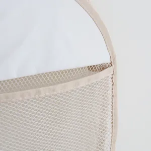 Close-up detail of white and beige mesh hanging storage bag showing fine stitching.