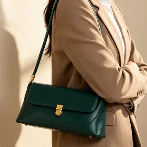 Green leather baguette shoulder bag detail featuring elegant metal clasp and sleek design.