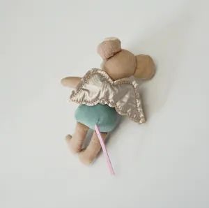 Miniature angel mouse detail, cute plush doll with gold wings and green shorts for dollhouse.