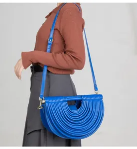 Blue semi-circular crossbody bag with unique textured piped design for women chic style.