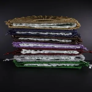 Handcrafted woven crescent bag detail showcasing colorful stacked design with white inner lining.