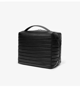 Black minimalist cosmetic storage bag with horizontal stripes, top handle and secure zip closure.