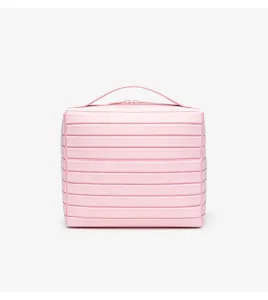 Detailed view of the pink cosmetic storage bag featuring stylish horizontal striped texture and handle.