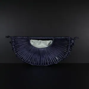Detailed view of handmade woven semi-circular crescent handbag with inner drawstring pouch.
