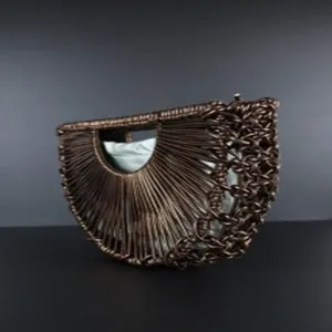 Handmade woven half-moon crescent bag detailed view, showcasing intricate dark brown structure.