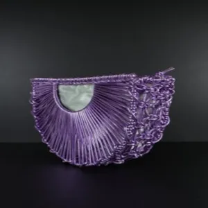 Purple metallic woven crescent bag detail, unique half-moon shape with inner pocket design.