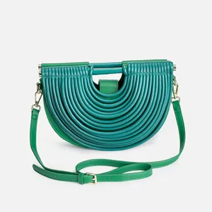 Green semi-circular crossbody handbag with unique ridged texture, stylish women bag.