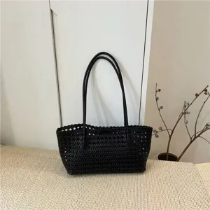 Black woven shoulder bag detail, vintage retro design, minimalist casual daily tote style.
