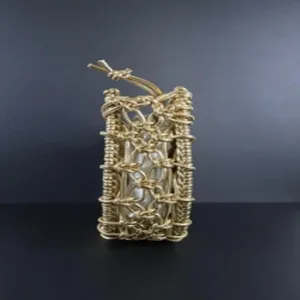 Detail view of the golden woven handbag showing intricate metallic rope mesh structure and design.