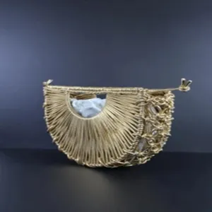 Detailed view of the handmade woven gold crescent handbag, featuring unique semi-circular handle.