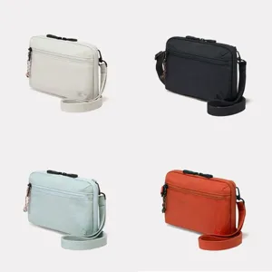 Multi-pocket nylon crossbody bag with adjustable strap and zip compartments for daily use.