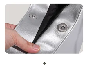 Silver PU leather shoulder bag detail, showing interior magnetic snap closure and lining.
