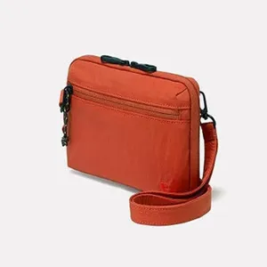 Orange multi-pocket crossbody bag detail, compact canvas shoulder bag with adjustable strap.
