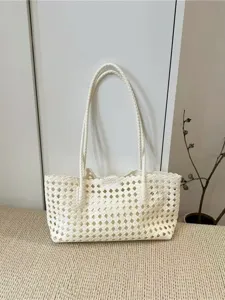 Close up of a stylish white woven shoulder bag detail, featuring an intricate mesh pattern.