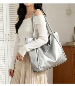 Detail view of the stylish silver metallic tote shoulder bag, modern commuting design.