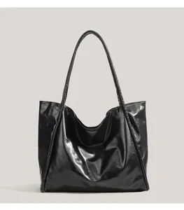 Minimalist black glossy shoulder tote bag for women, large capacity commuting daily handbag.