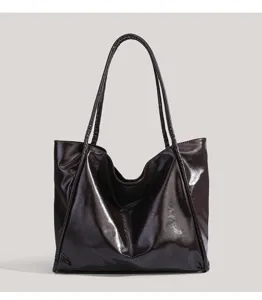 Detailed view of the glossy patent leather tote bag showing smooth texture and large capacity.