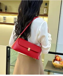 Elegant red leather shoulder bag for women, stylish underarm baguette bag with gold lock.