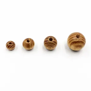 Natural wood beads close up detail showing different sizes and unique grain patterns for DIY crafts
