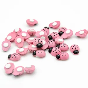 Detailed shot of cute pink wooden ladybug ornaments with adhesive backing for DIY craft decor.
