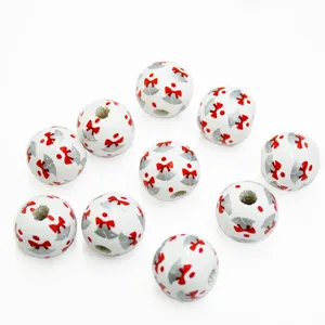 Close-up detail of 16mm wooden beads with Christmas bow patterns for crafts and jewelry design.