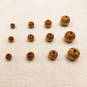 Natural pine wood round beads in assorted sizes from 6 to 30mm for DIY jewelry making crafts.