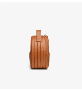 Detailed side view of brown ridged hard shell cosmetic travel bag, portable handle design.