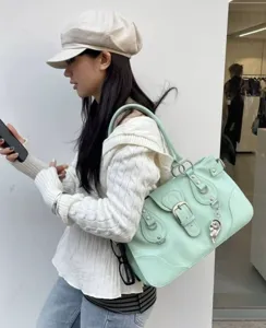 Y2K mint green shoulder bag, Korean commuter tote with buckles and unique street design.