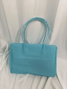 Light blue PVC jelly tote bag with shoulder straps and white stitching, large capacity handbag.