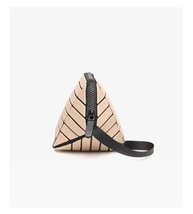 Detail shot of the trendy geometric lattice triangular cosmetic pouch and portable lipstick bag.