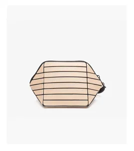 Detailed view of a chic beige geometric striped cosmetic and handbag, showing unique slat design.