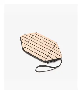 Geometric panel clutch bag in beige with black zipper and wrist strap, compact makeup pouch.