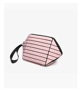 Pink geometric lattice makeup pouch portable cosmetic bag with handle detail view.