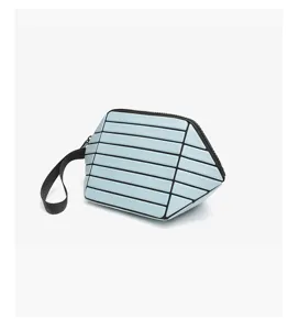 Light blue geometric panel clutch bag with wrist strap, trendy minimalist cosmetic pouch.