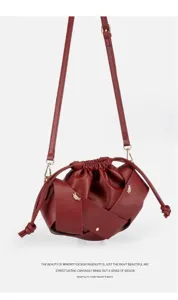 Stylish red pleated crossbody bag featuring woven strap and PU leather drawstring bucket design.