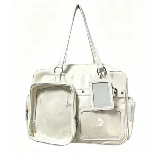 Detailed close-up view of white ita bag with multiple clear PVC window pockets for pin display.