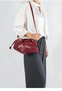 Wine red woven leather shoulder bag with knot details, stylish and elegant cross-body handbag.