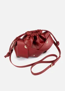 Red PU leather crossbody bag with drawstring closure and stylish wrapped knot design for women.