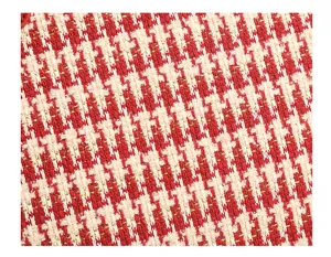 Red and white houndstooth fabric detail with subtle gold shimmer texture closeup shot.